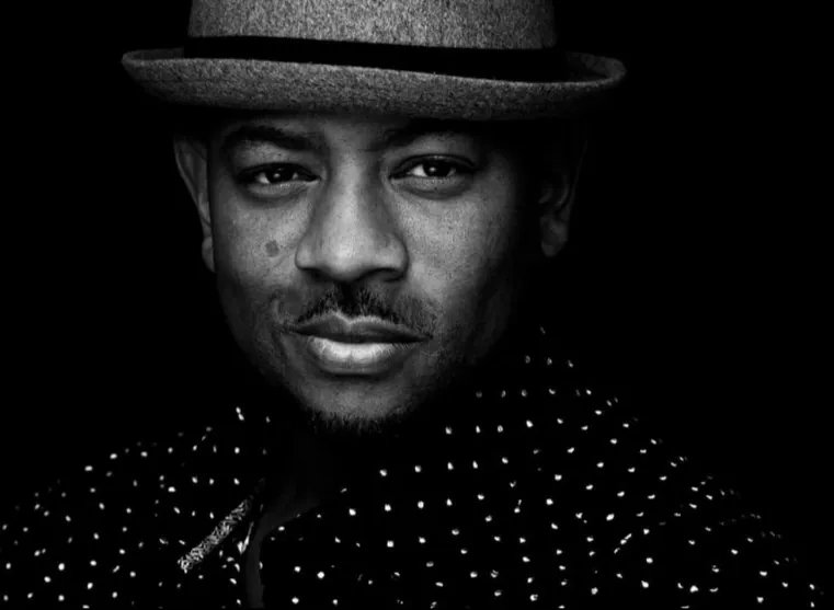 Black-and-white portrait of Dr. Loyce E. Spells II wearing a hat
