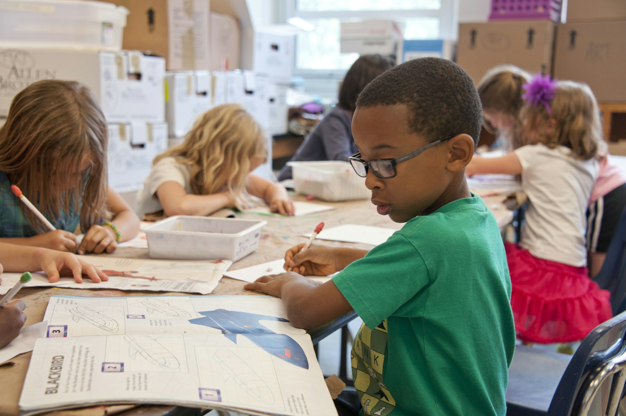 Elementary students working together at a classroom table