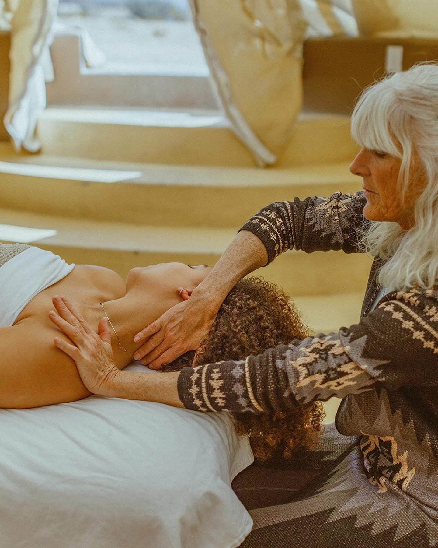 Kate Healy, LMT providing hands-on bodywork to a client’s neck and shoulders