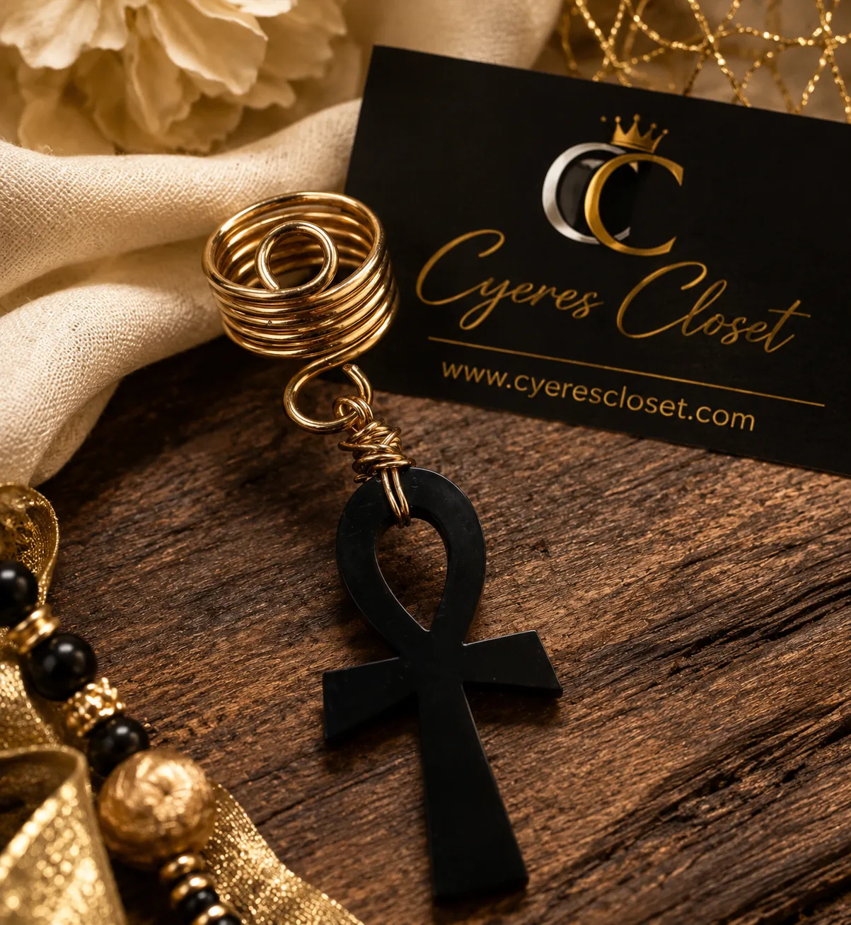 Black ankh loc charm wrapped in gold-tone wire