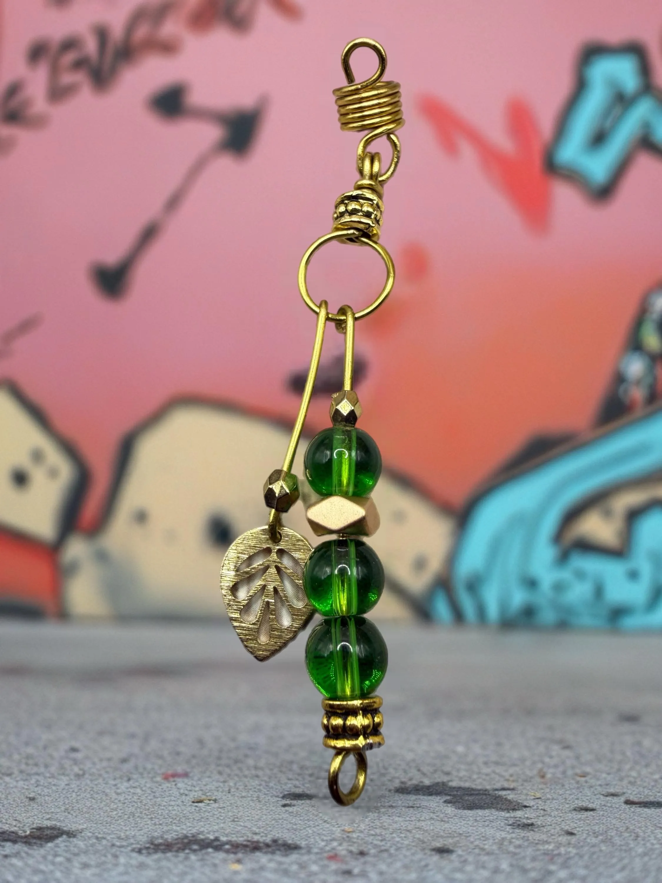 Handmade gold leaf loc jewelry with colorful bead accents