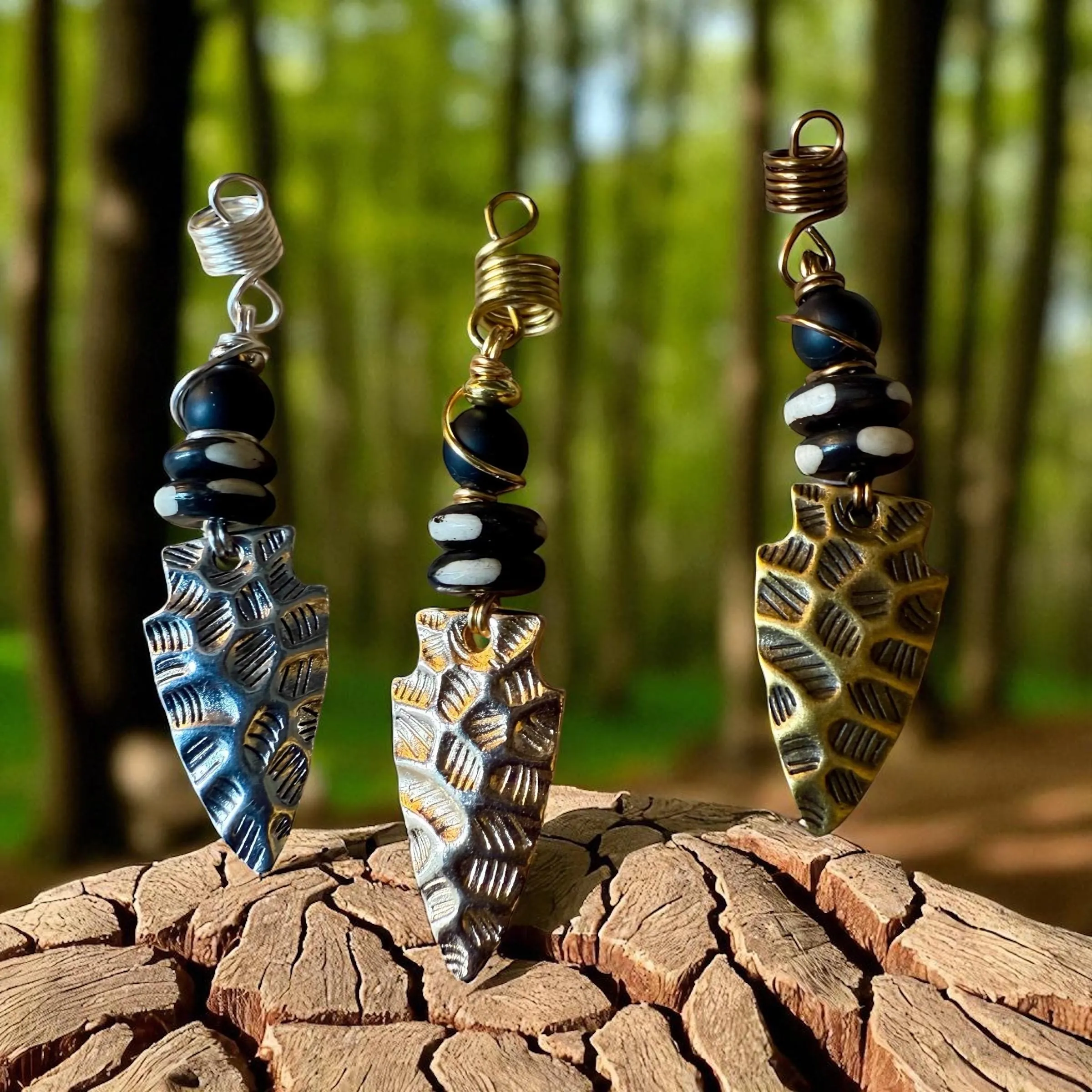 Arrowhead loc jewelry charm with gold, bronze, and silver wire wrap