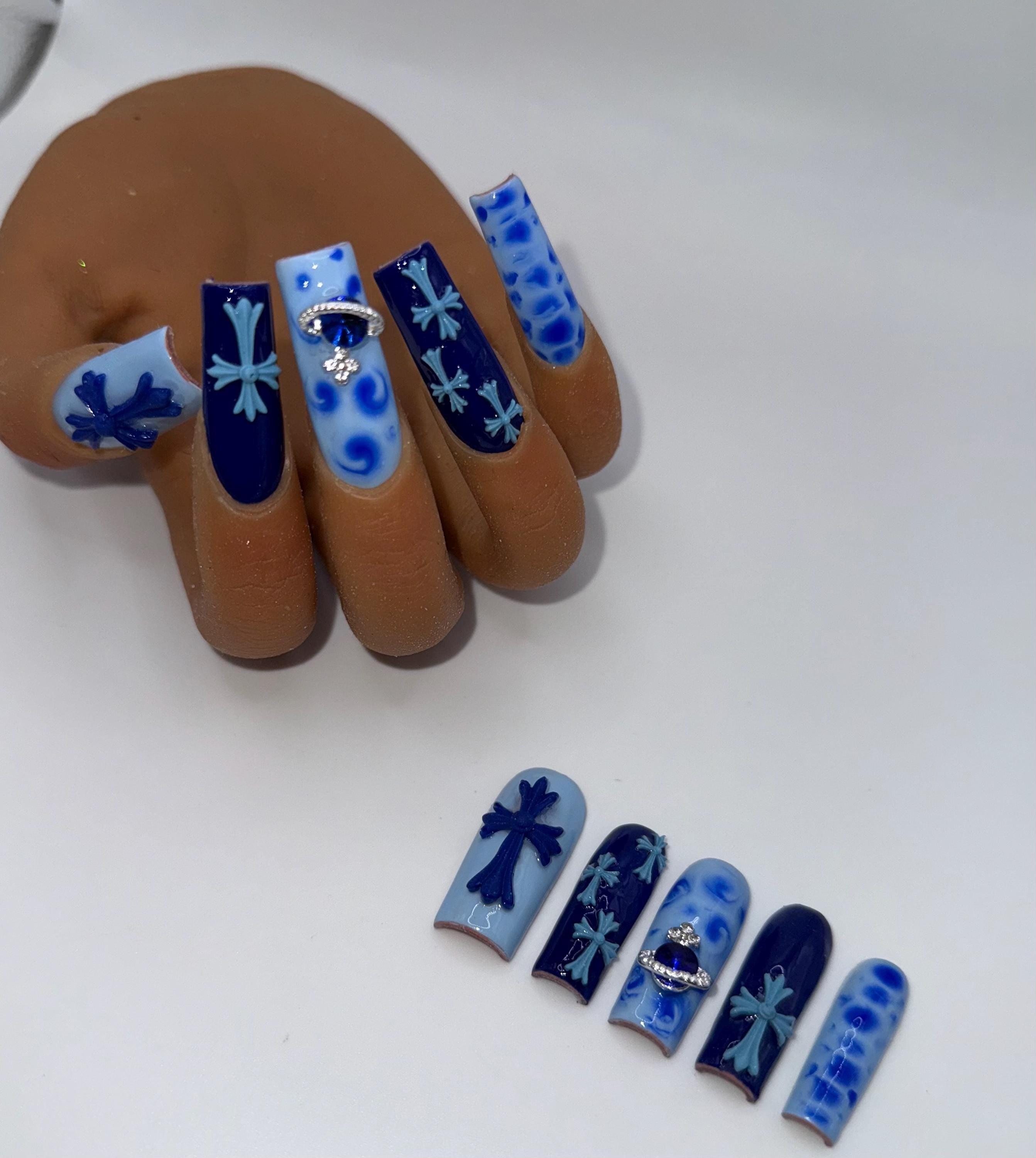 A blue BBJD handmade press-on nail set with detailed art