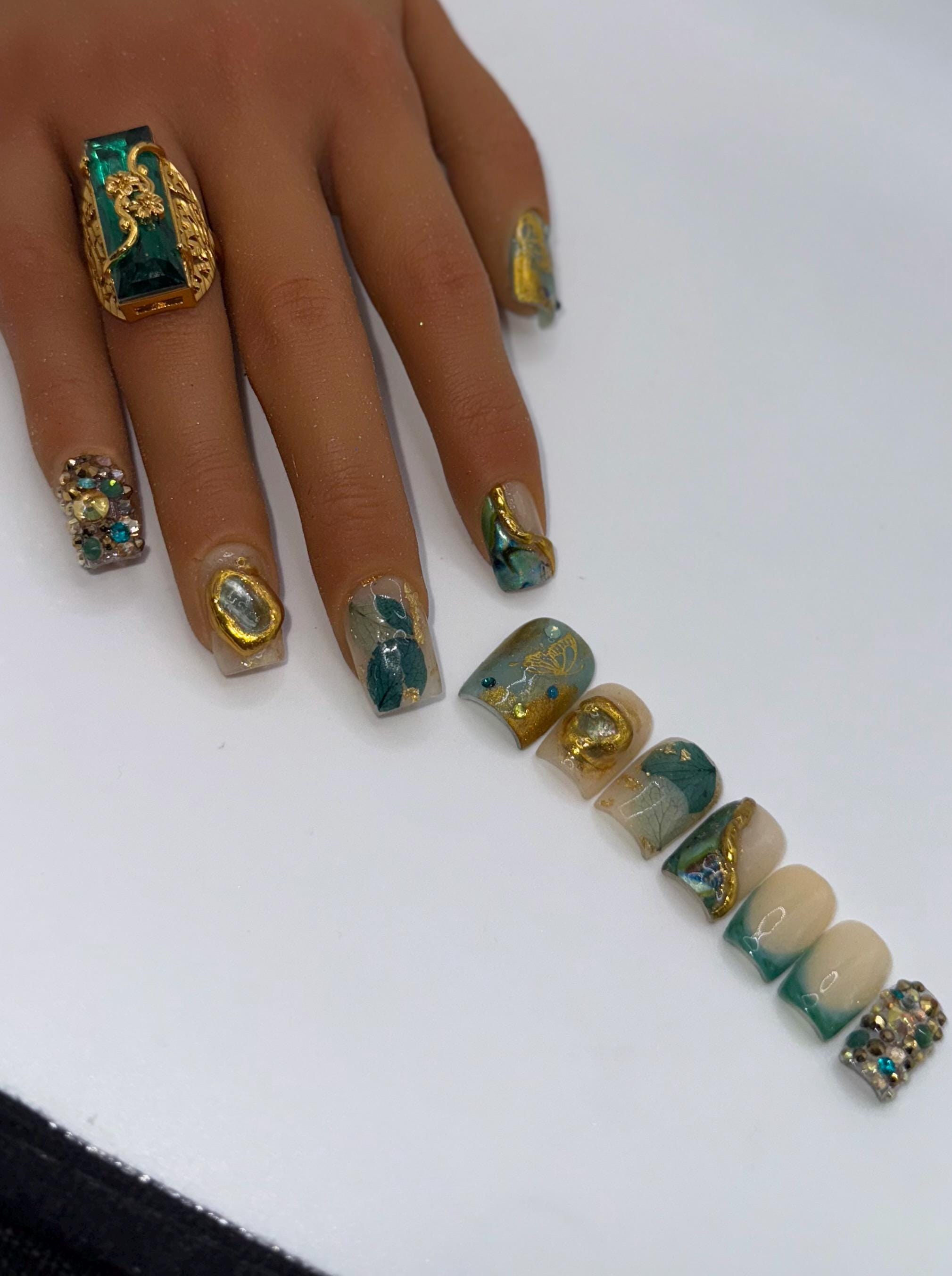 A green and gold BBJD press-on nail set with dimensional art