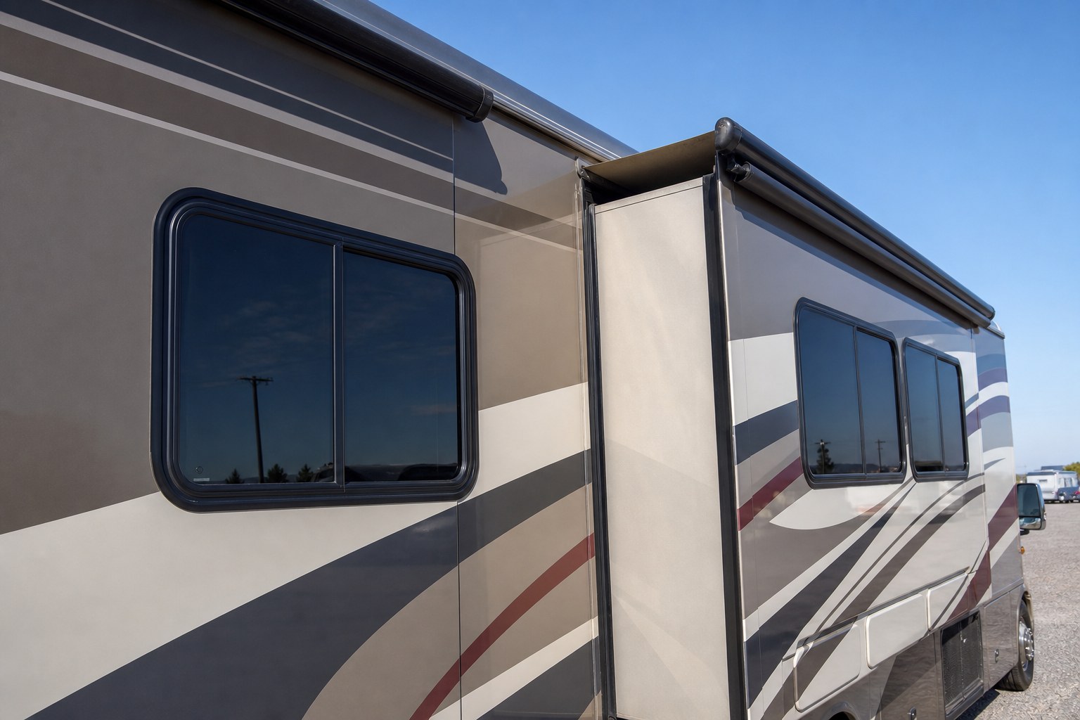 Motorcoach exterior with windows, roofline, and slide-out seal visible