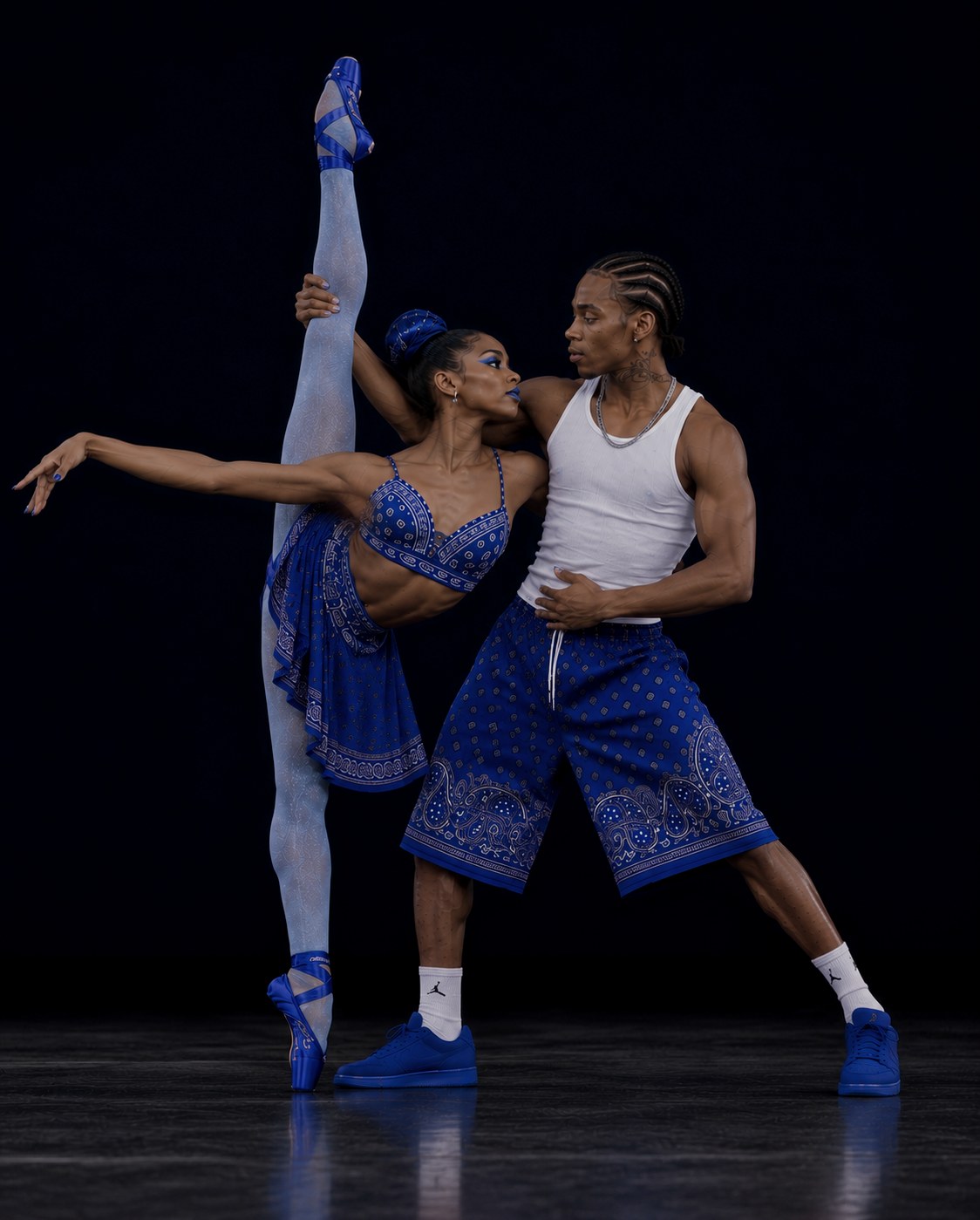 Two dancers in cobalt blue performance styling