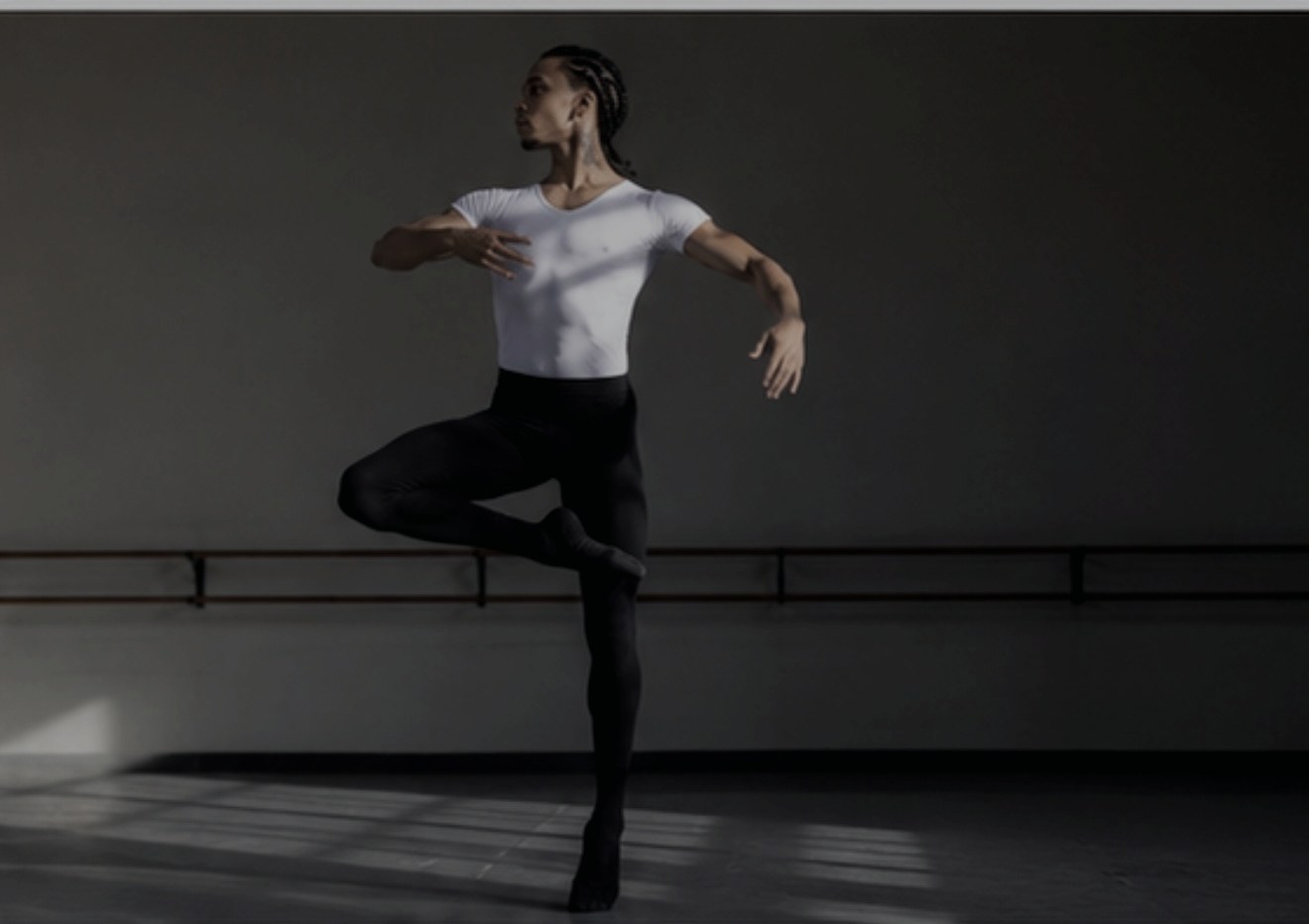 Dancer training at a ballet barre