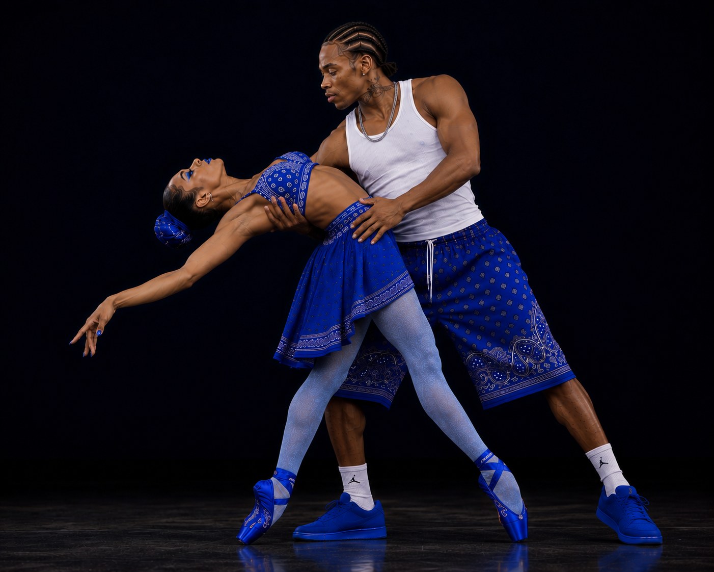 Two LAX BLaaK dancers in blue performance styling holding a dramatic supported dip