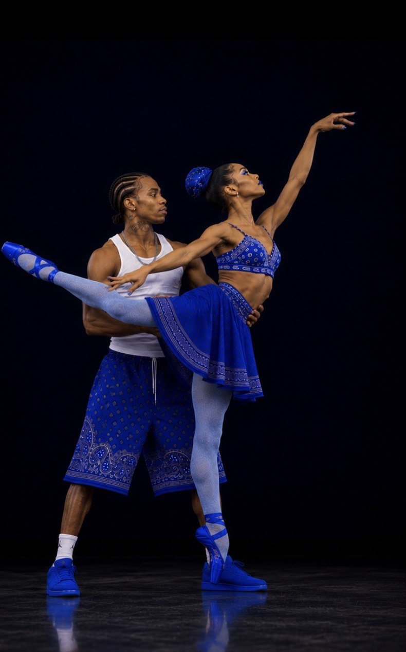 Two LAX BLaaK dancers in blue performance styling holding a high extension