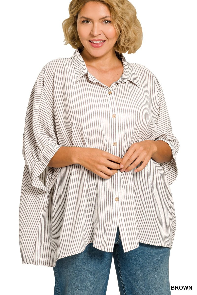 Plus-size striped button-down as an open layer over a denim outfit