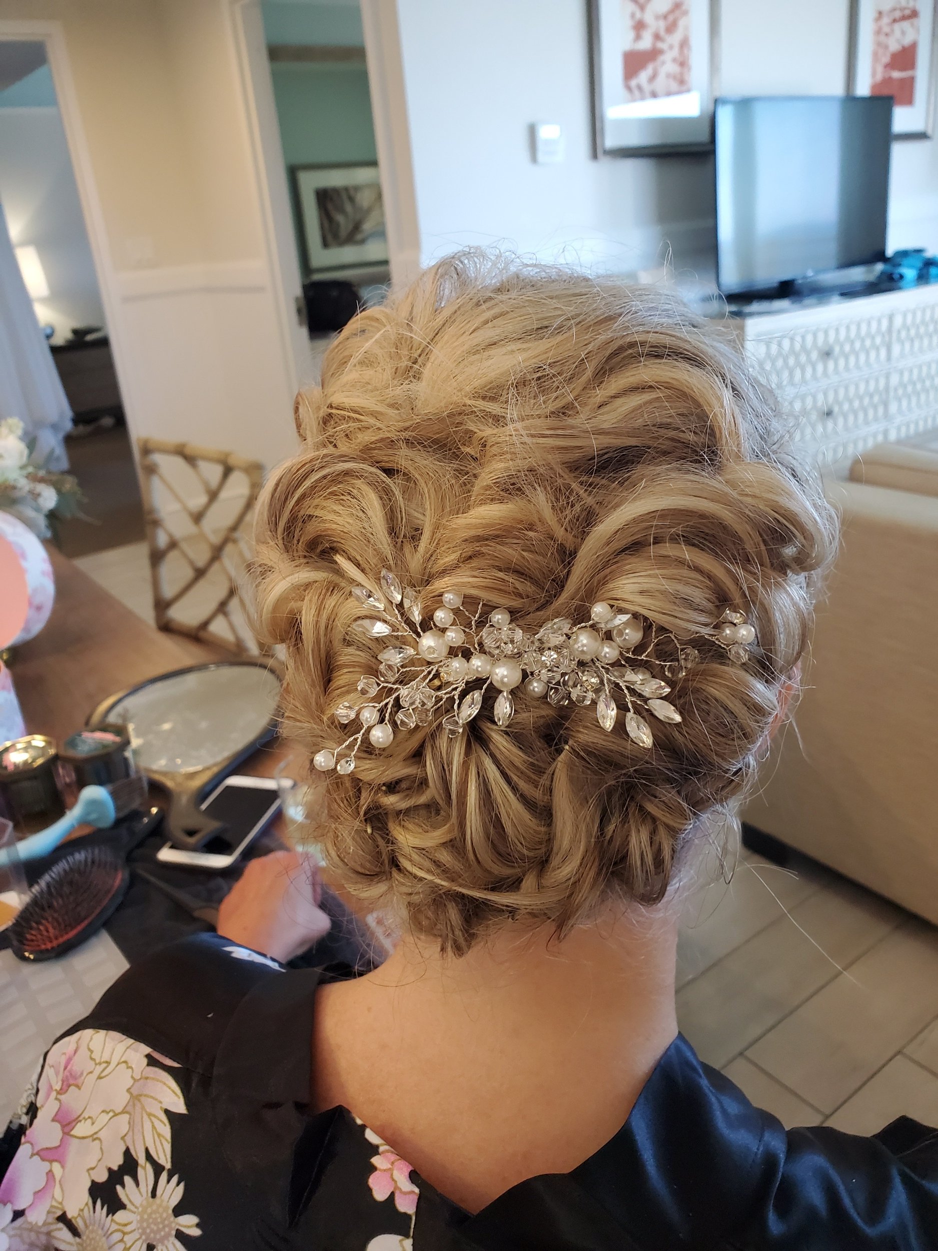 Intricate blonde updo finished with a jeweled hair comb