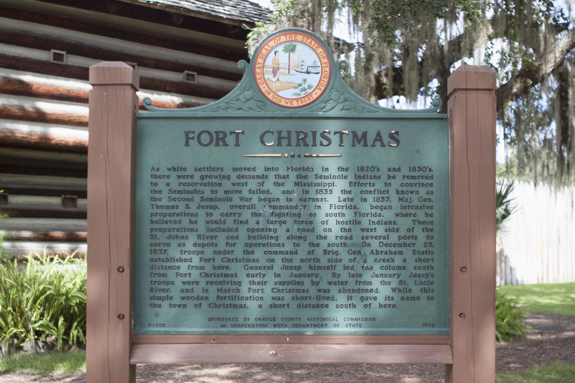 Fort Christmas historical marker beside the reconstructed log fort