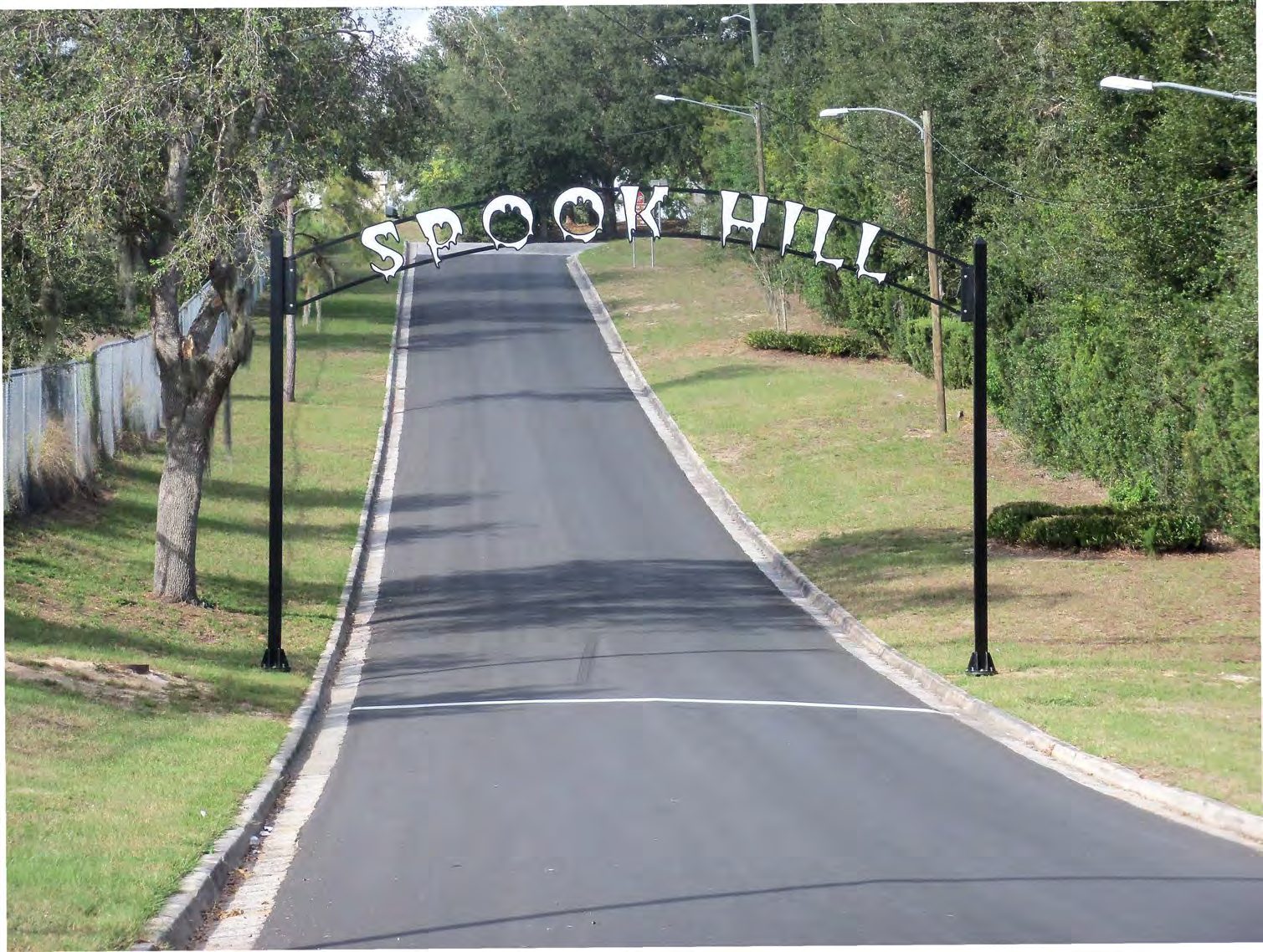 Spook Hill archway and white starting line on North Wales Drive in Lake Wales