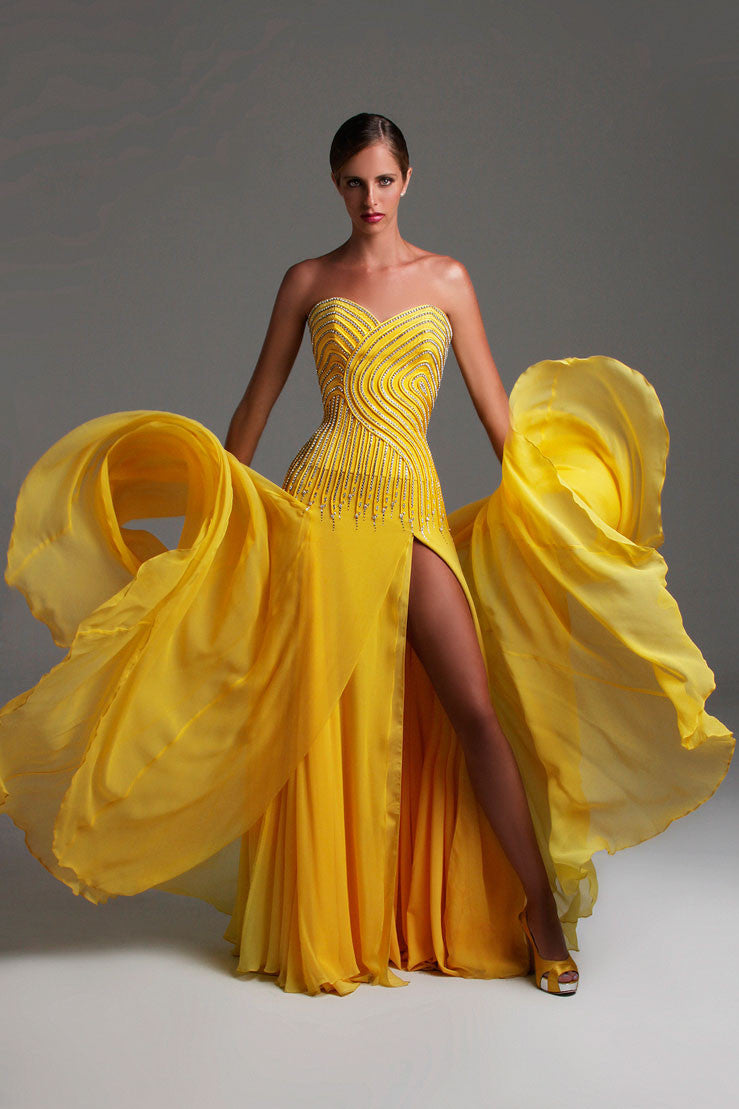 Yellow couture pageant gown with beaded bodice and flowing skirt