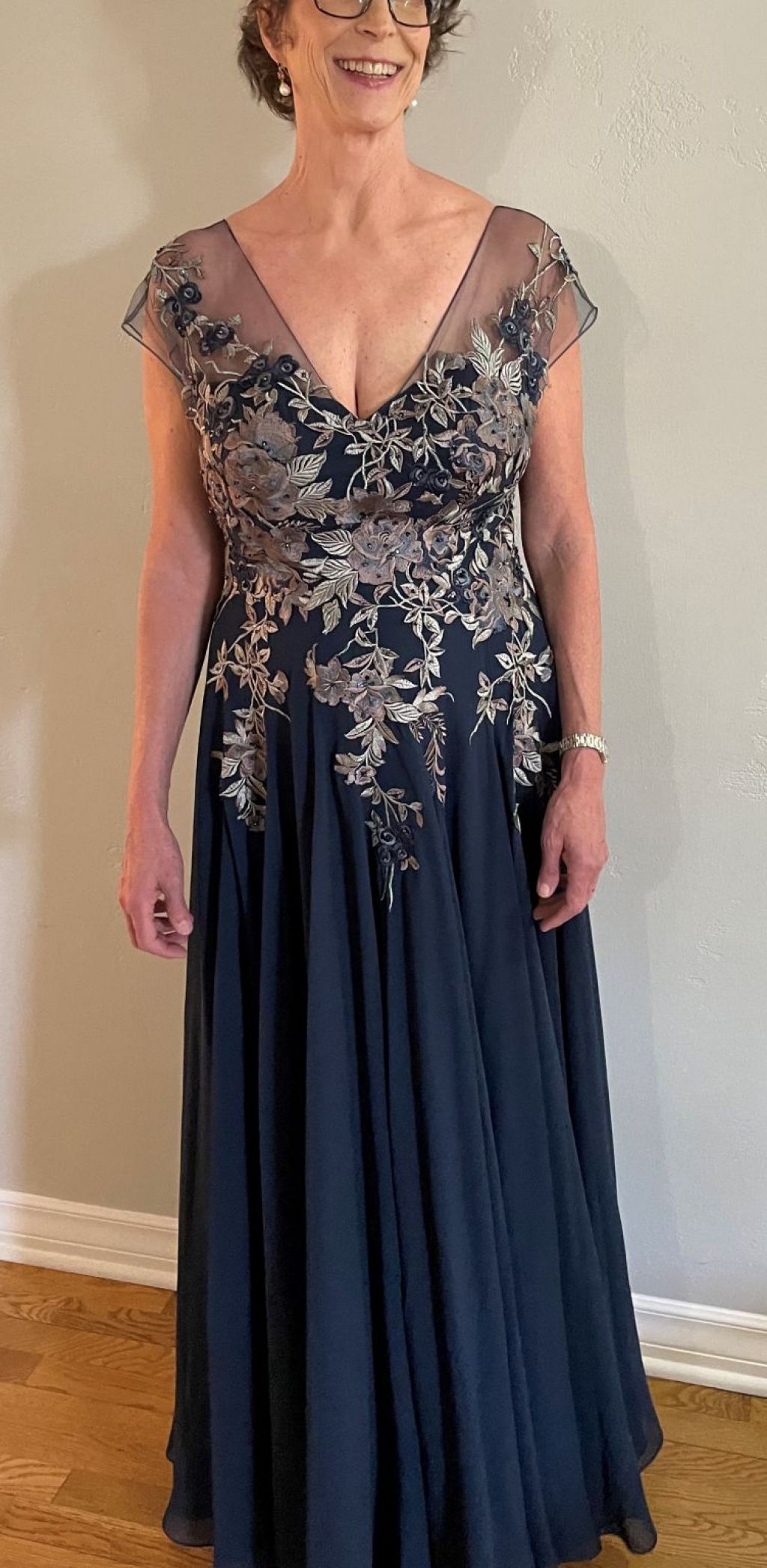 Navy formal gown with floral embroidery and a flowing skirt