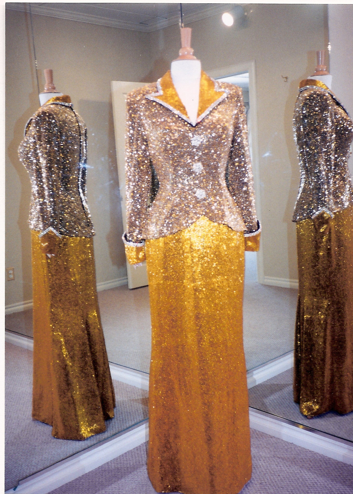 Gold liquid-beaded formal gown displayed from the front and sides