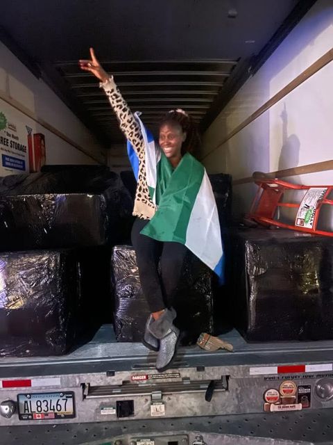 A volunteer beside a supply truck