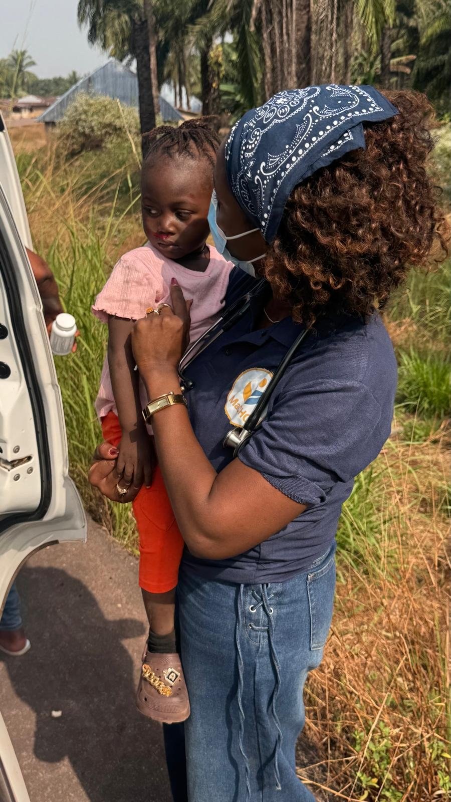 A MaCHO clinician comforting a young girl injured in a motorcycle accident