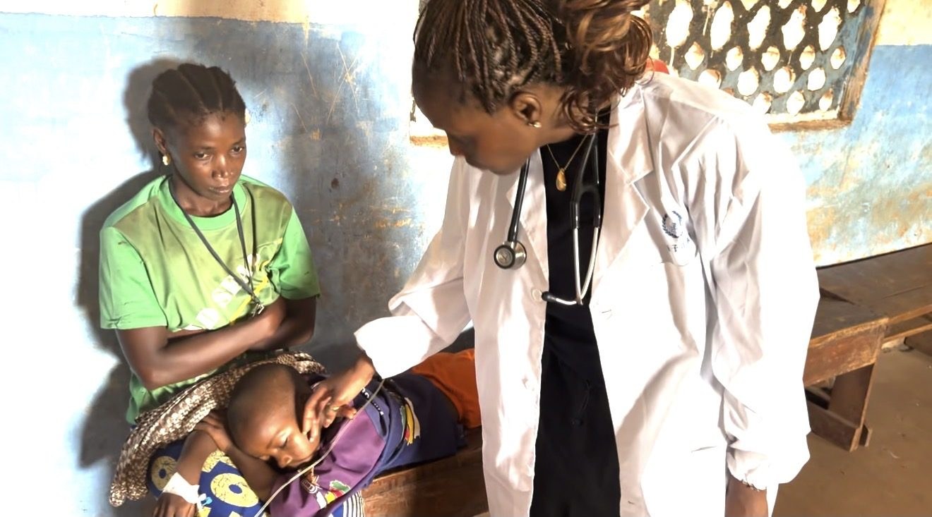 A MaCHO clinician examines a young child with a family member