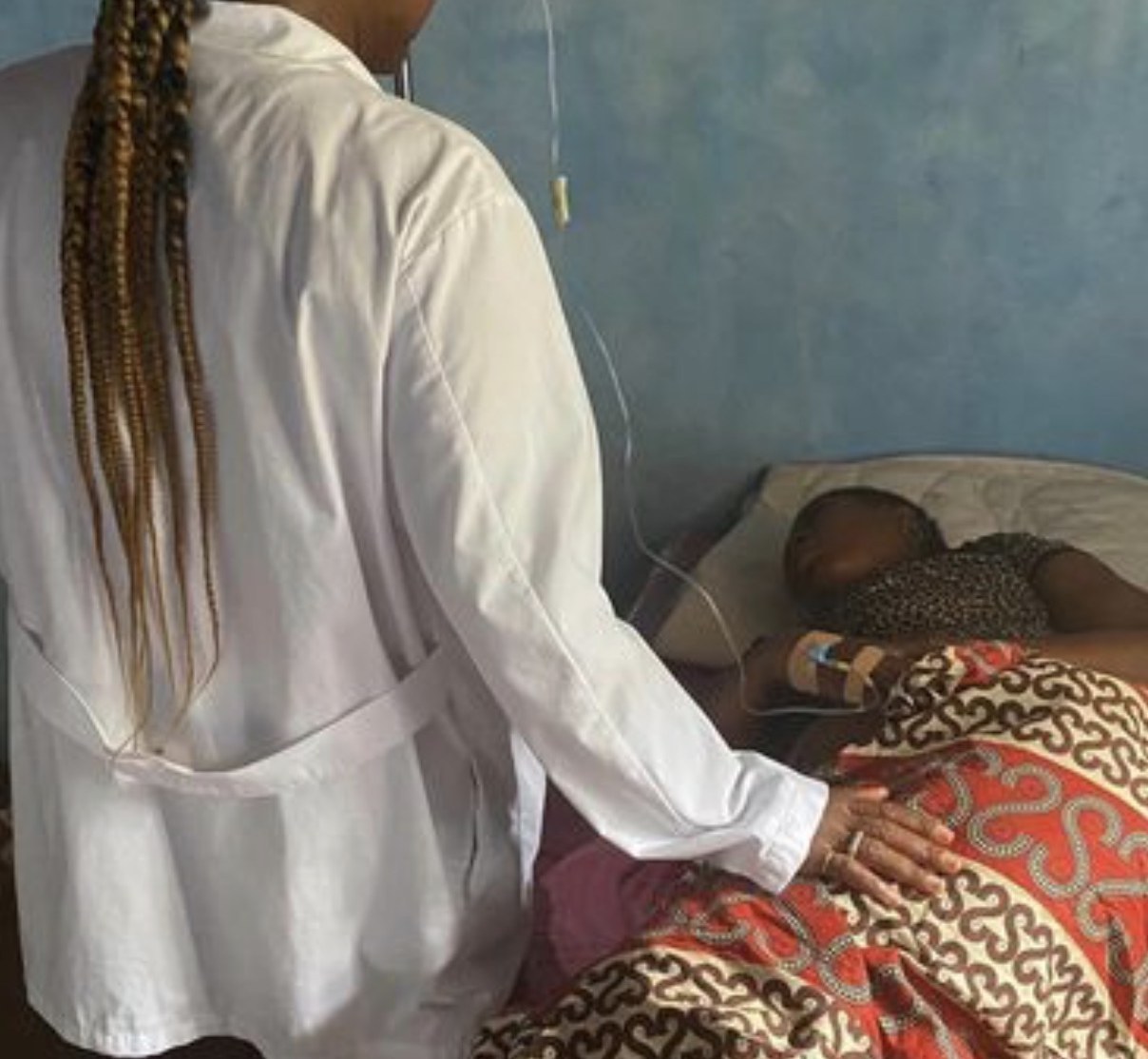 A MaCHO clinician beside a patient receiving IV fluids