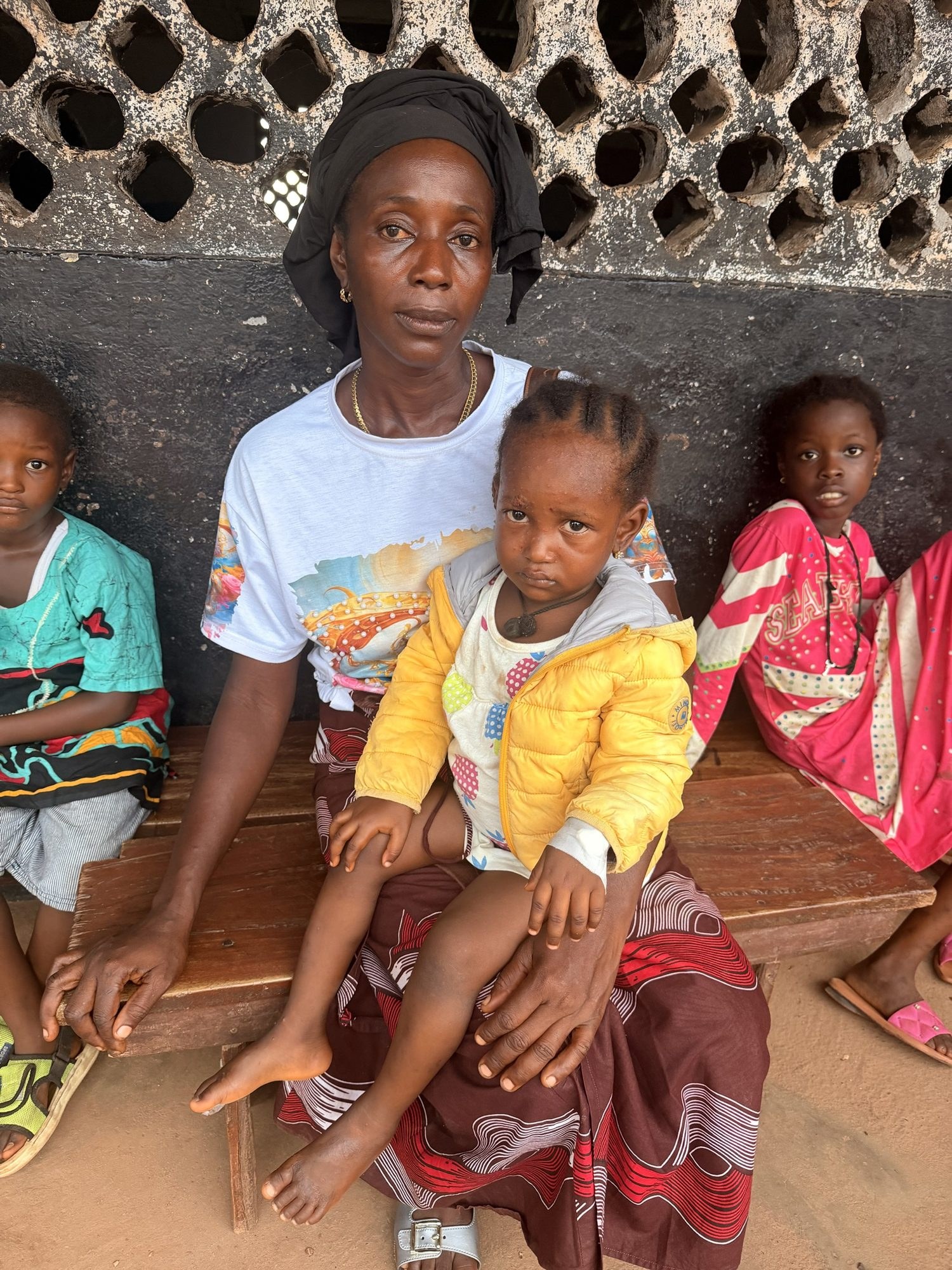 A mother and her children waiting for care