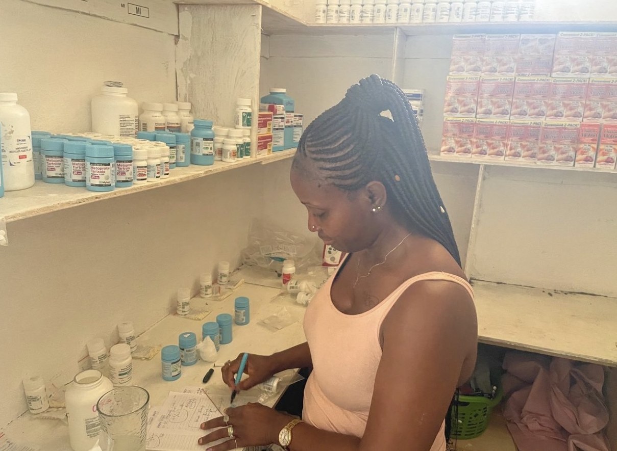 A MaCHO team member managing medications in the clinic pharmacy