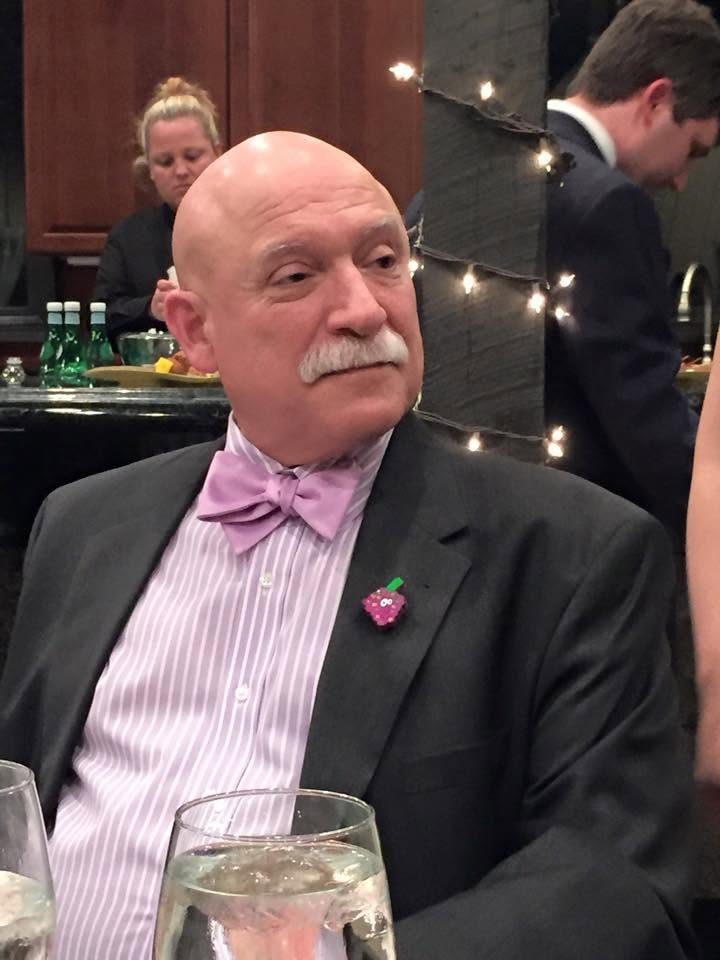 Steven Klass wearing a dark jacket and lavender bow tie