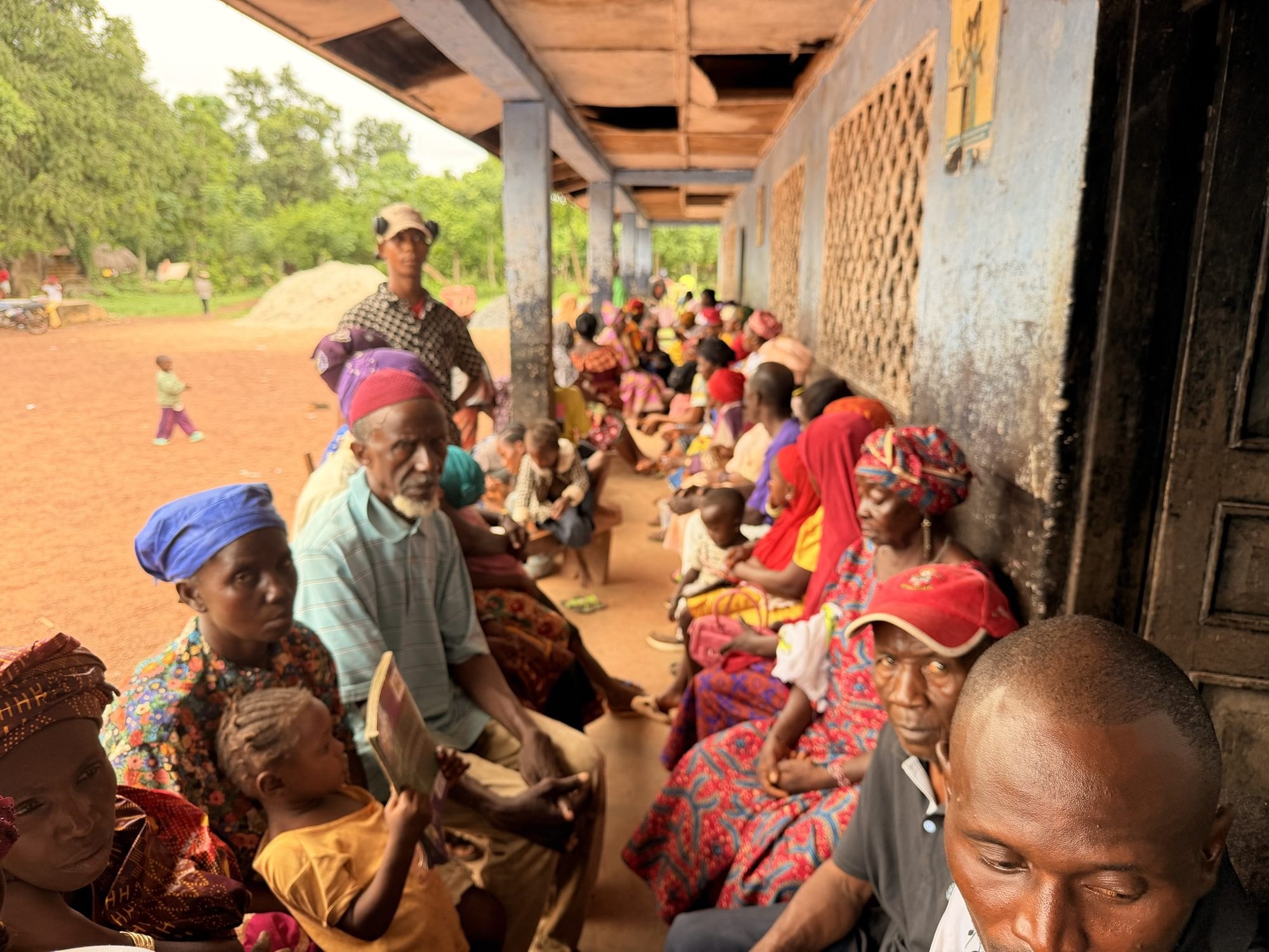 Families waiting along a clinic veranda