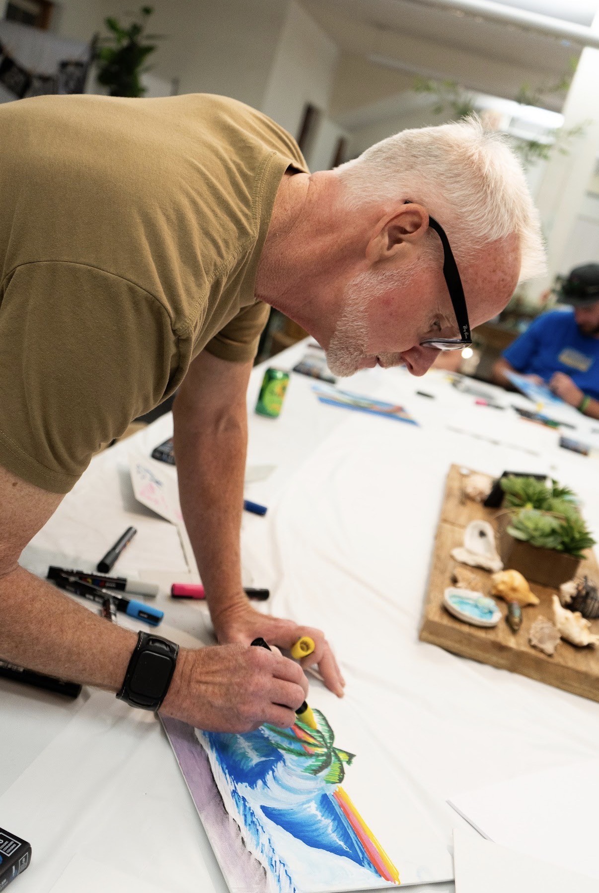 John Lasonio painting with acrylic markers in his studio