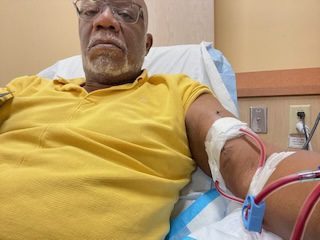 Keith Junor working from his dialysis chair