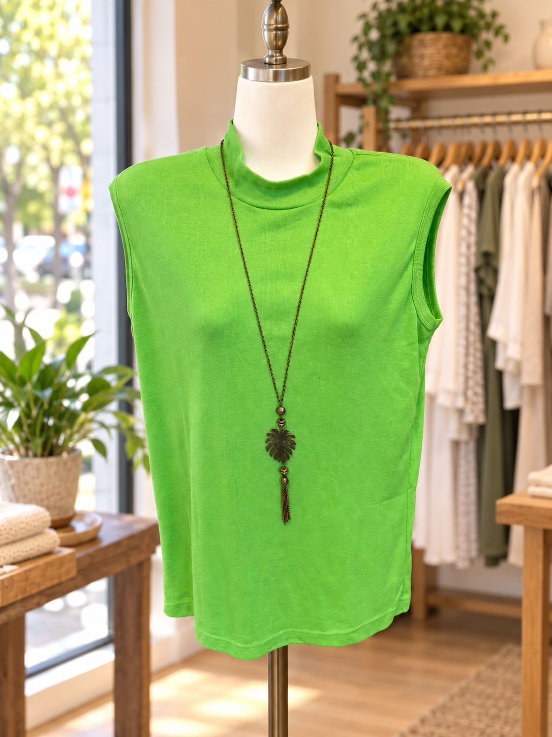 Neutral cotton t-shirt, crewneck, and cap on a wooden rail