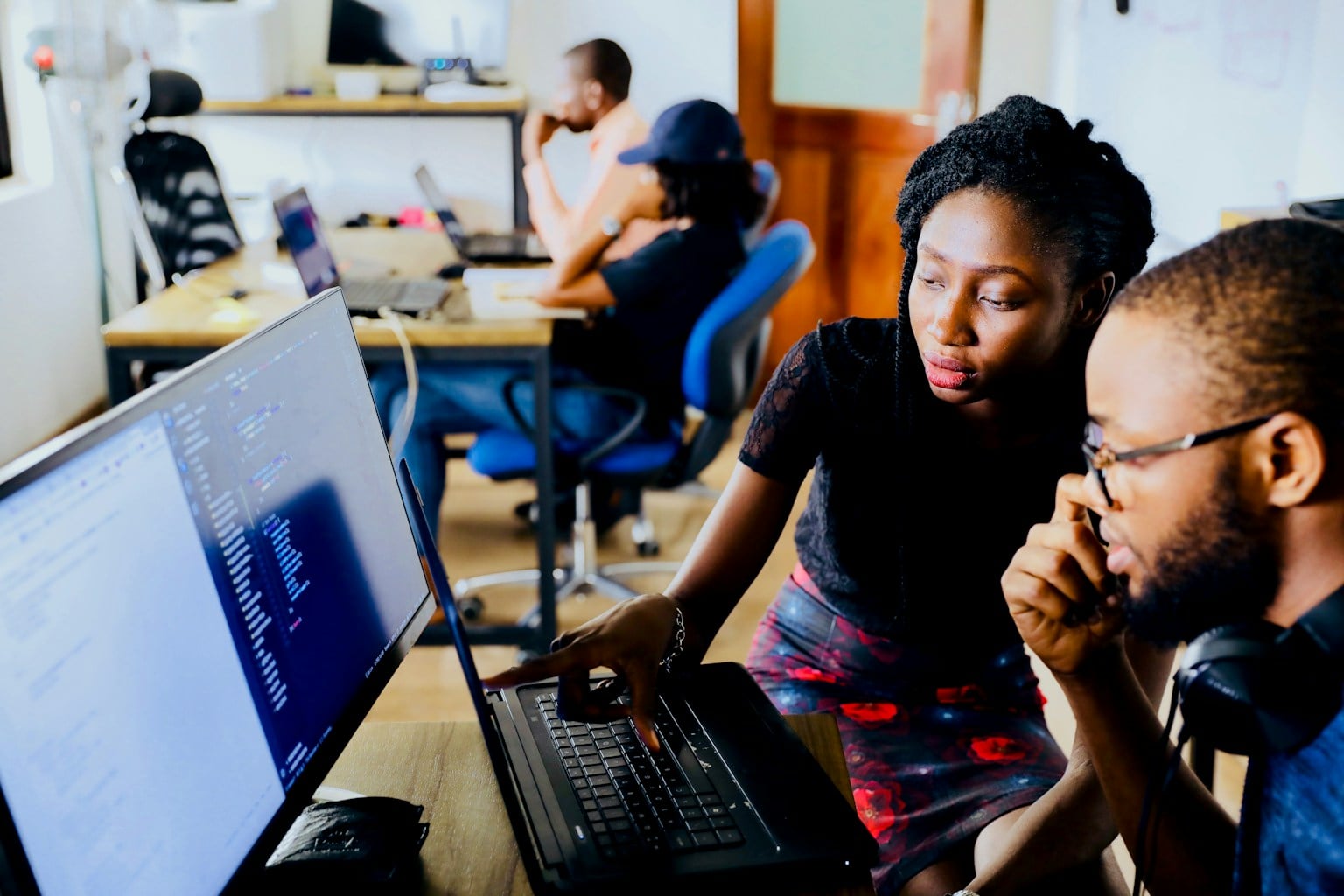 Two people having a focused conversation while working together