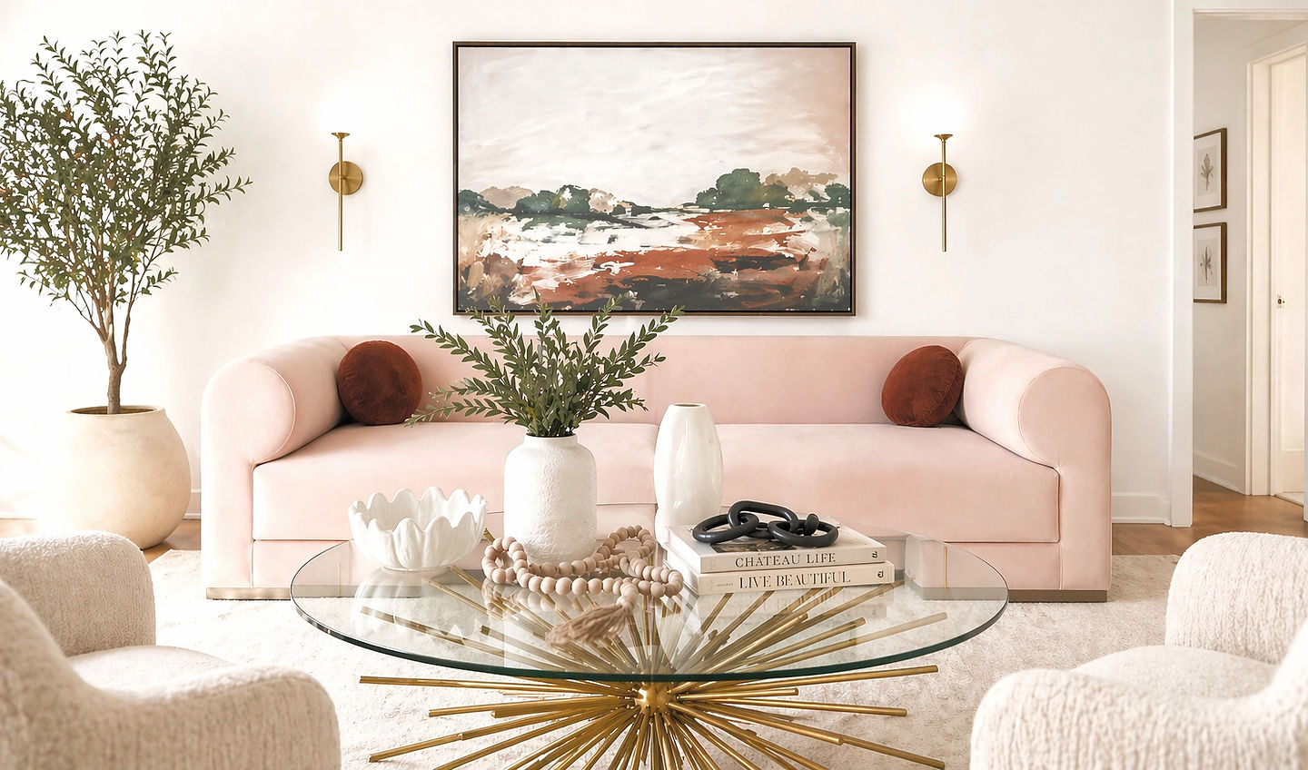 A staged living room with warm seating, art, and a coffee table