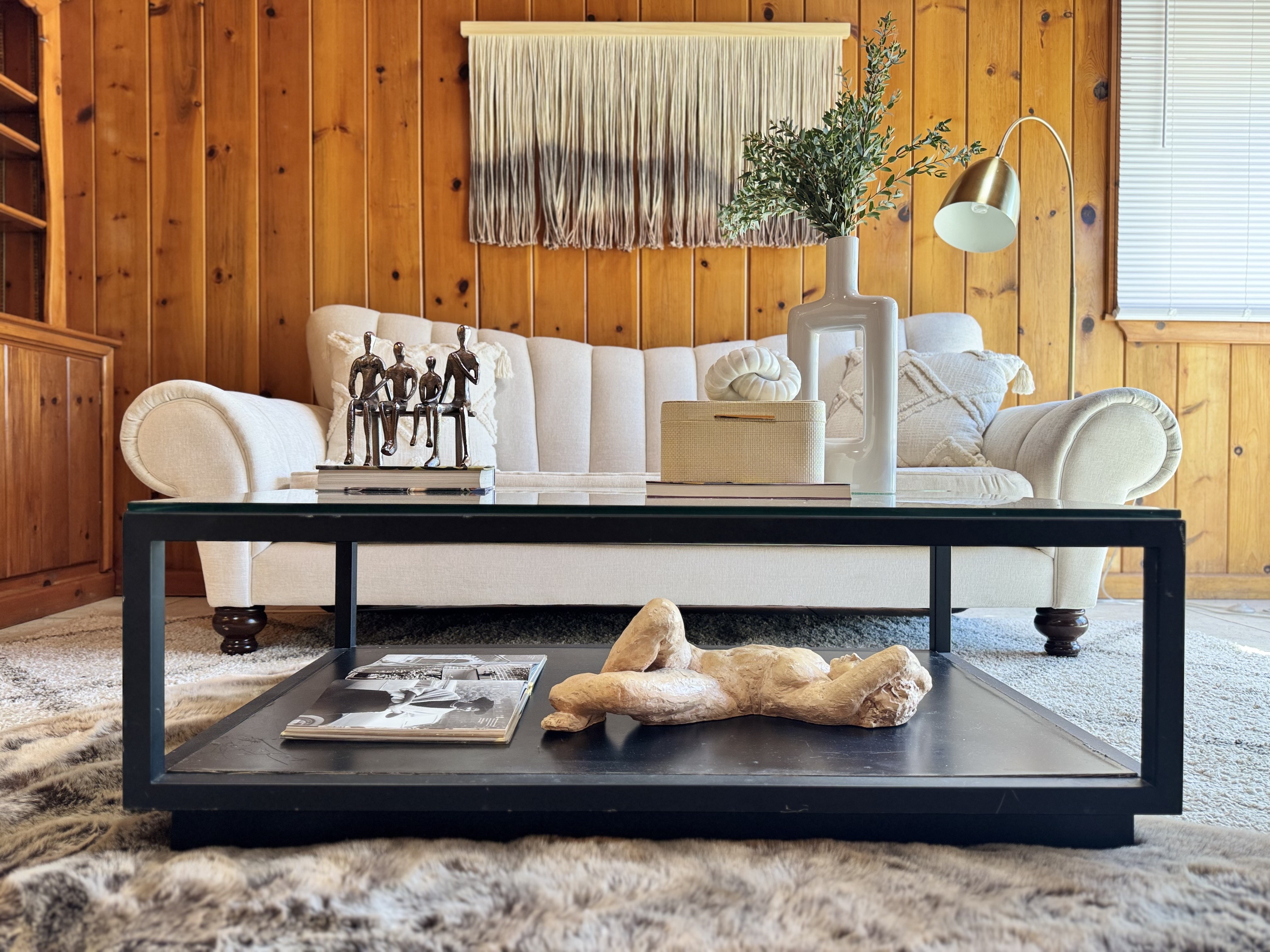 Standard staged wood-paneled living room, designed to help homes sell faster and above asking price
