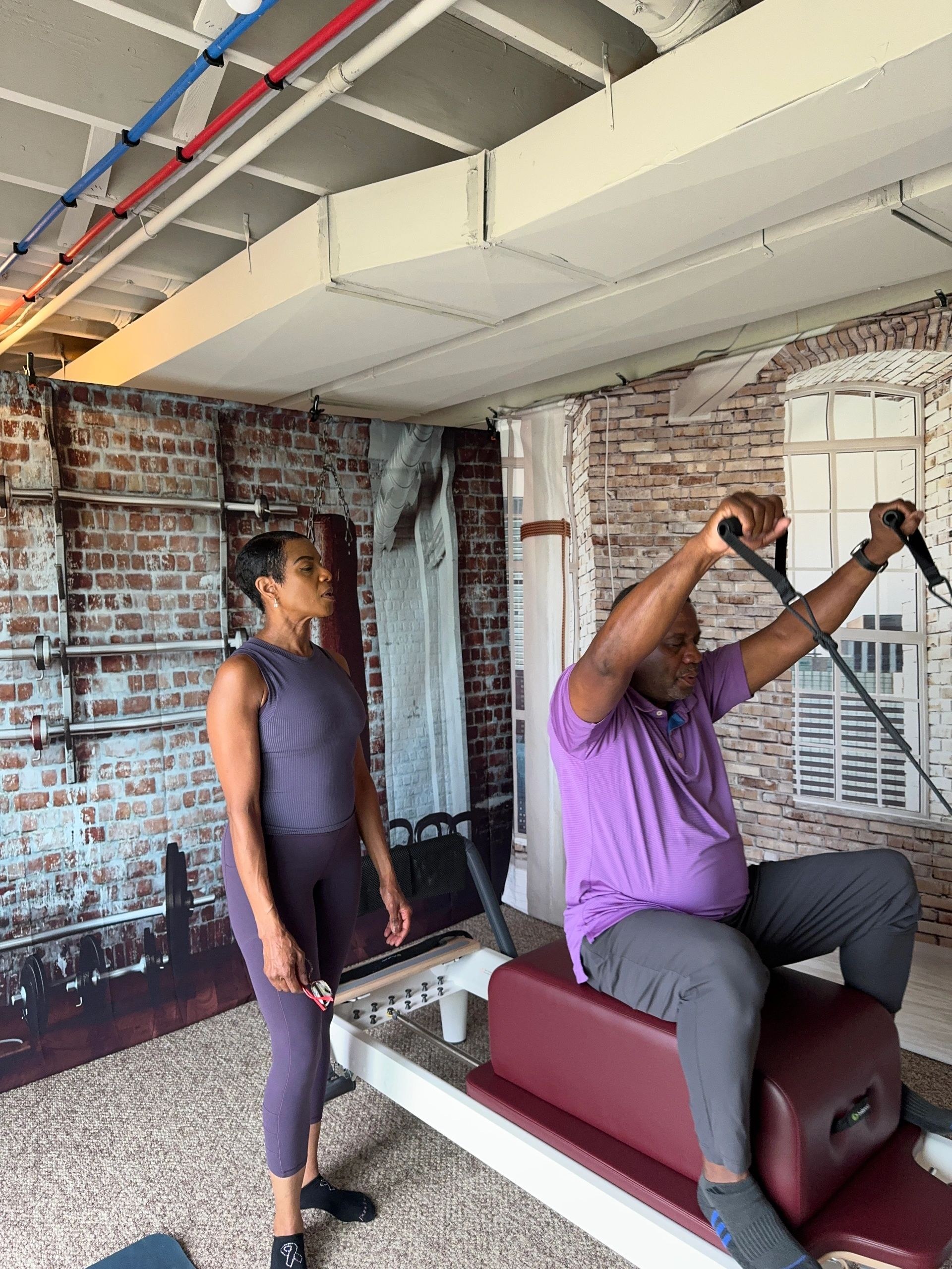 Nicole working on a Pilates reformer during a private training session