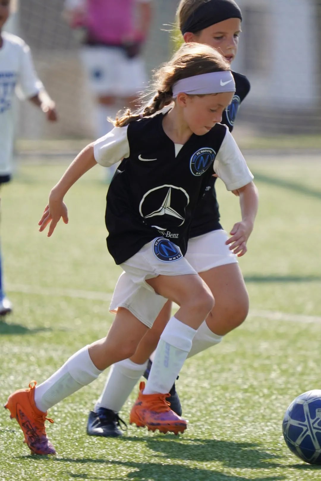 Young soccer player working with a ball at FC National training