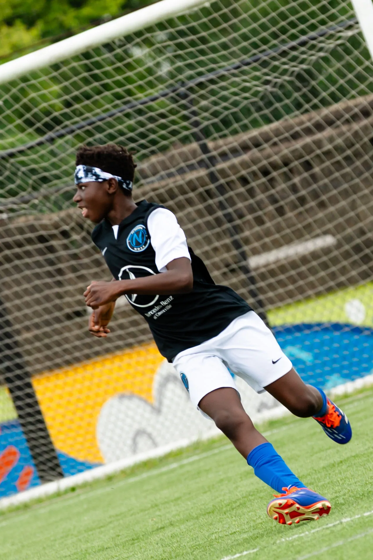 FC National player sprinting during an outdoor soccer session