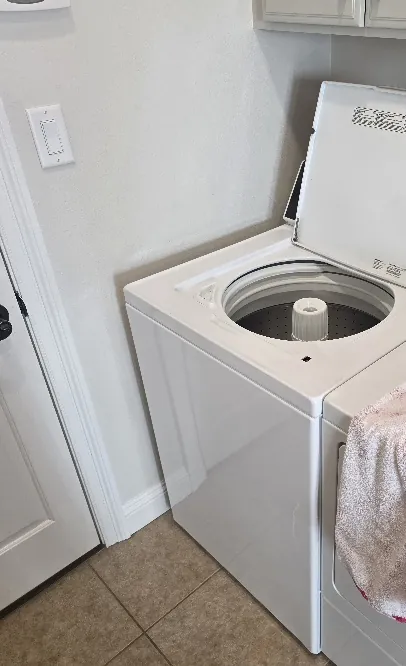 Washer being serviced in a home laundry area