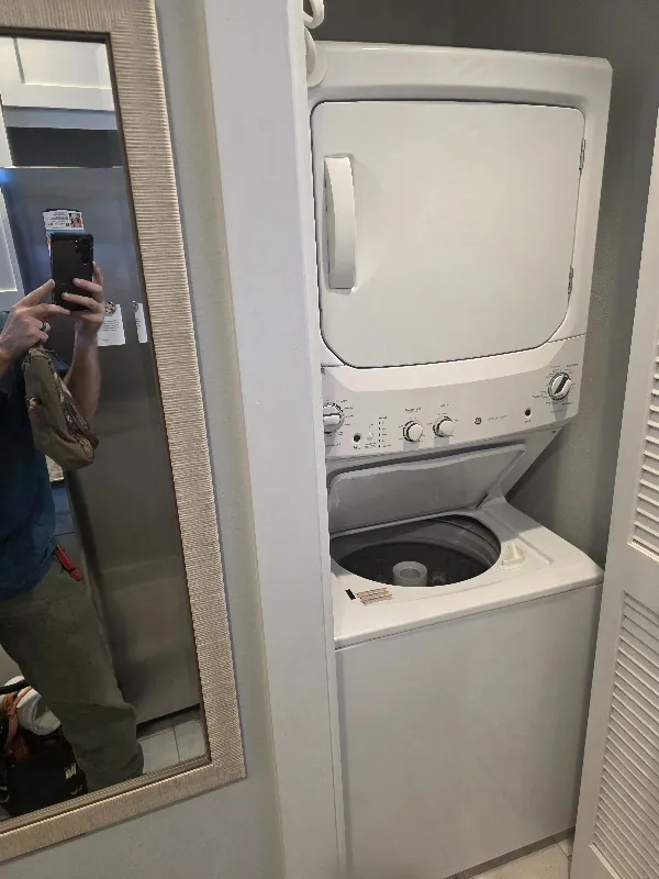 Compact laundry center with a washer and dryer in one assembly
