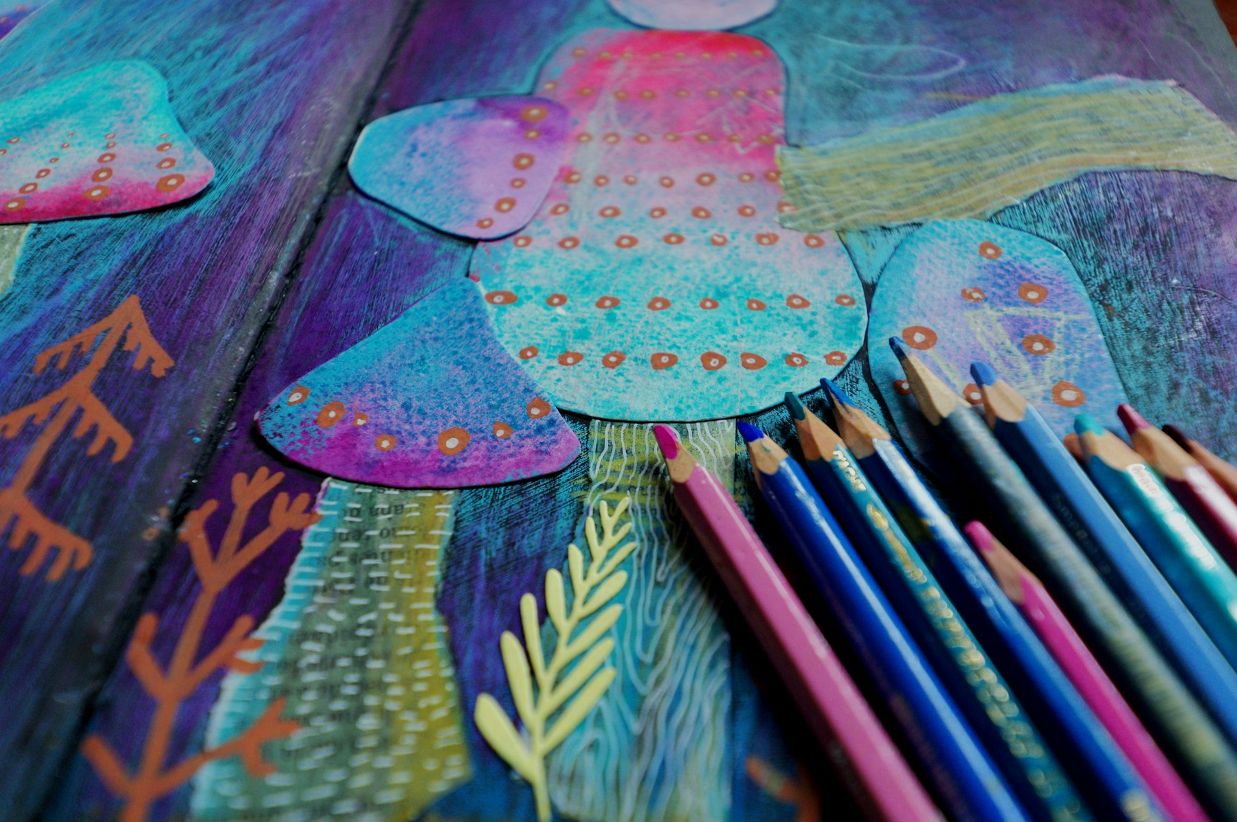 Colorful paper artwork and colored pencils on a desk