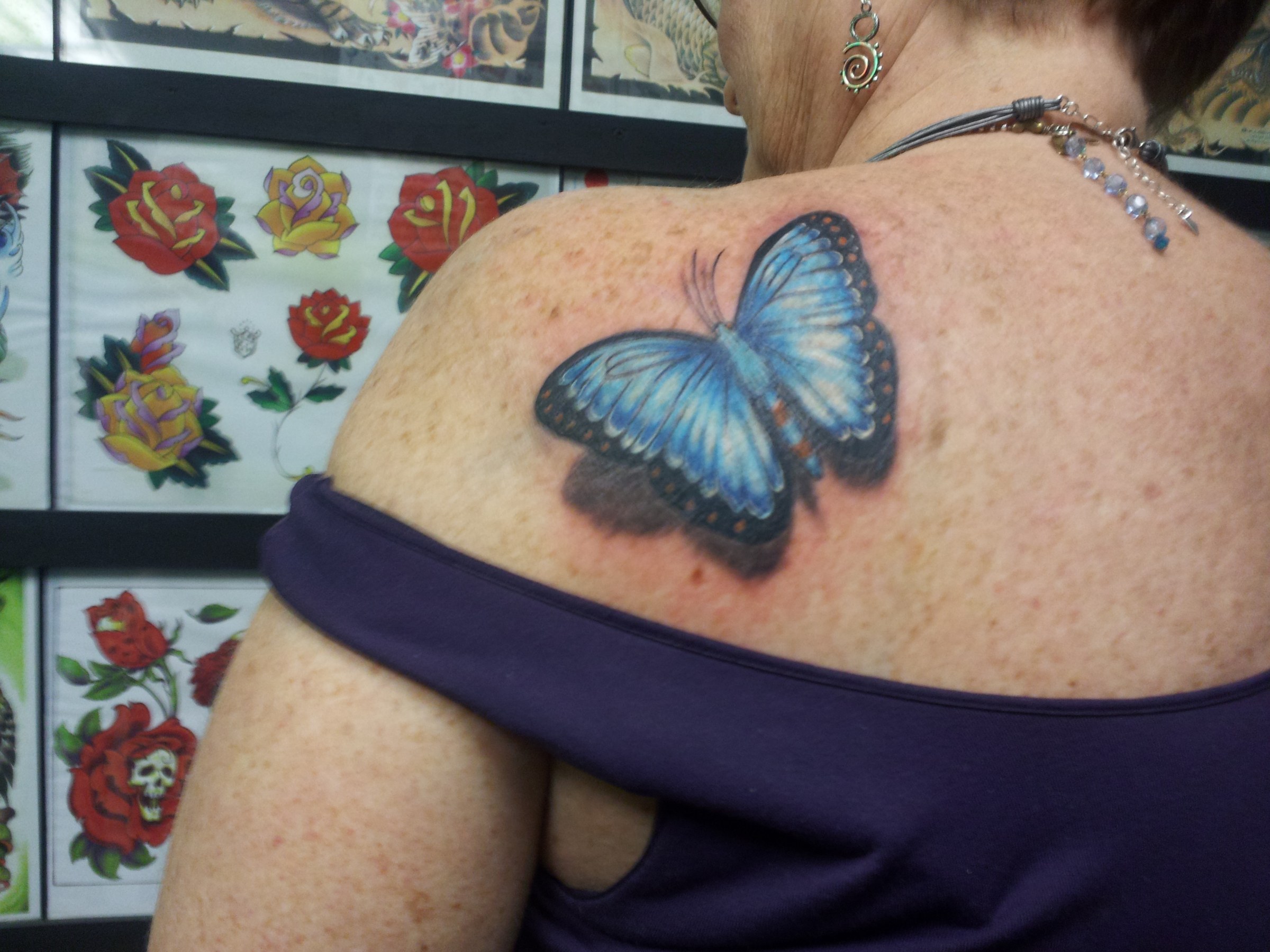 Blue butterfly tattoo by Joe Kennedy