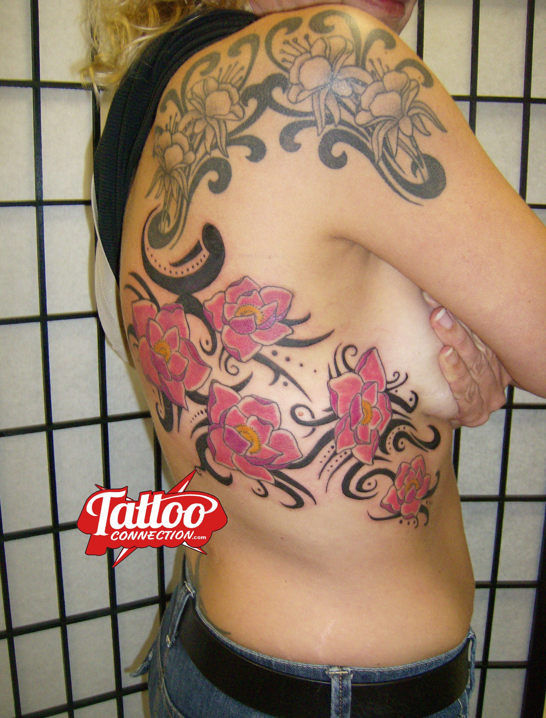 Flowers and tribal tattoo by Joe Kennedy
