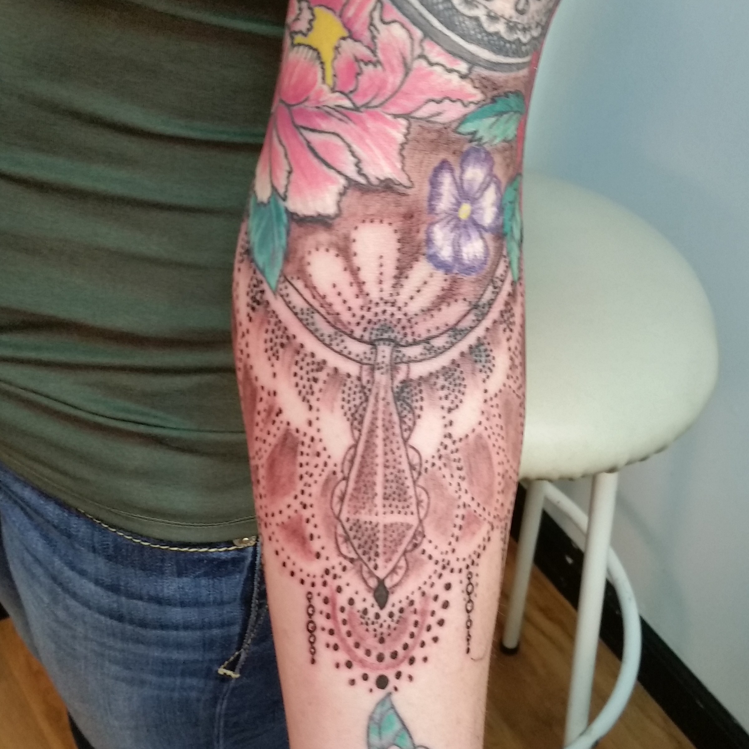 Ornamental floral forearm tattoo by Joe Kennedy