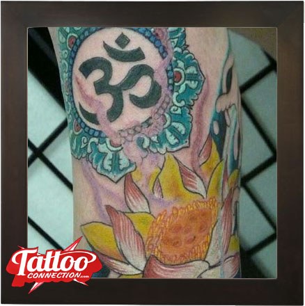Lotus and Om tattoo by Joe Kennedy