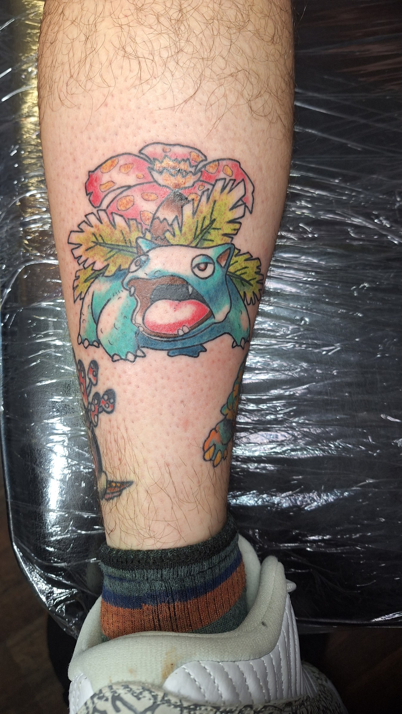 Colorful Bulbasaur tattoo by Rob Scotti