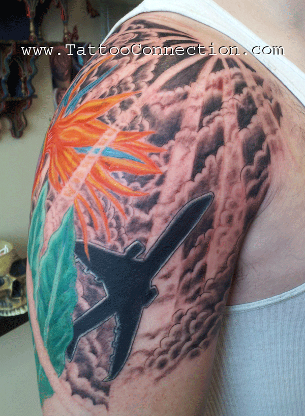 Bird-of-paradise flower and hummingbird shoulder tattoo by Joe Kennedy