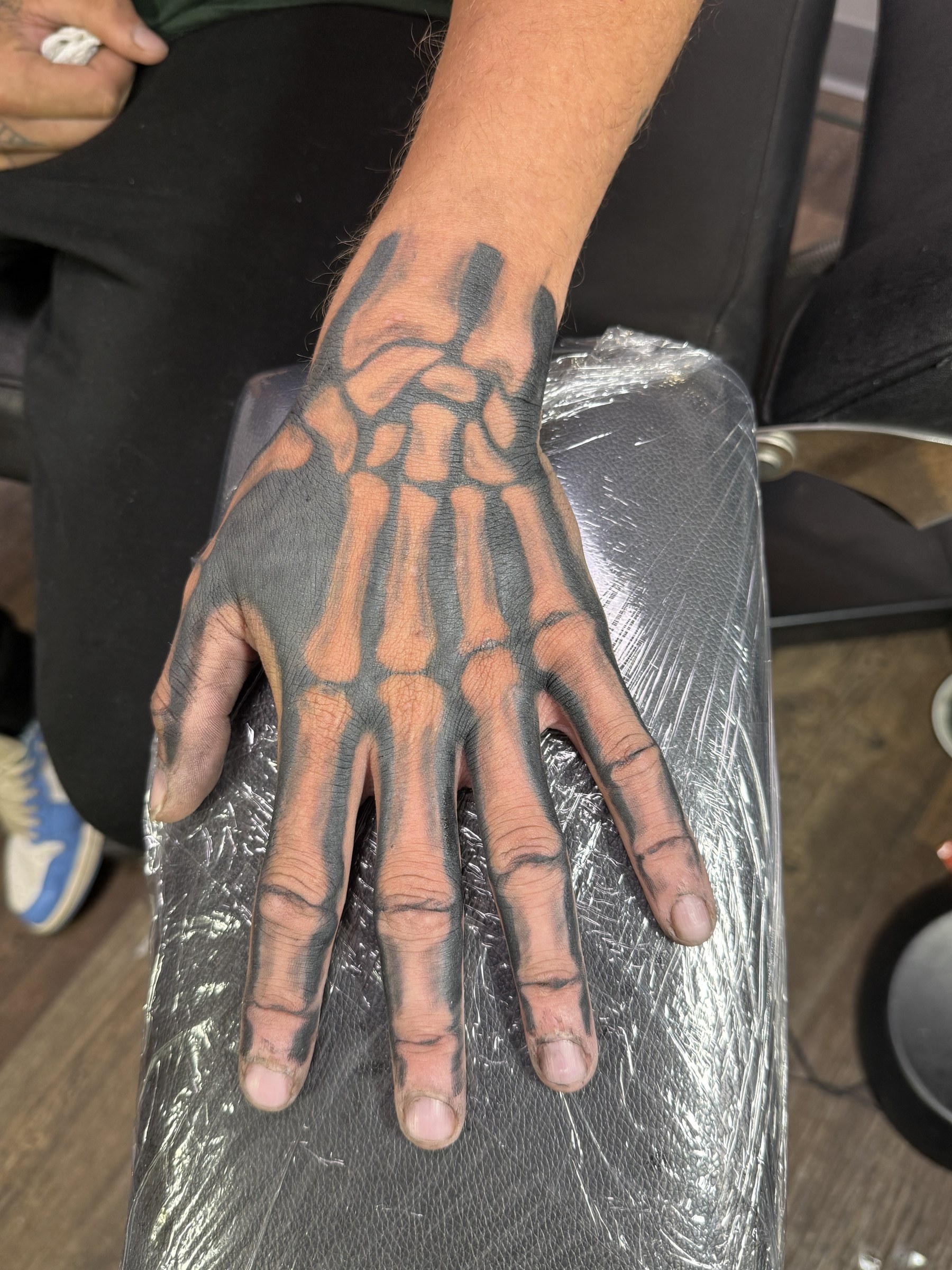 Blackwork skeletal hand tattoo by Joe Kennedy