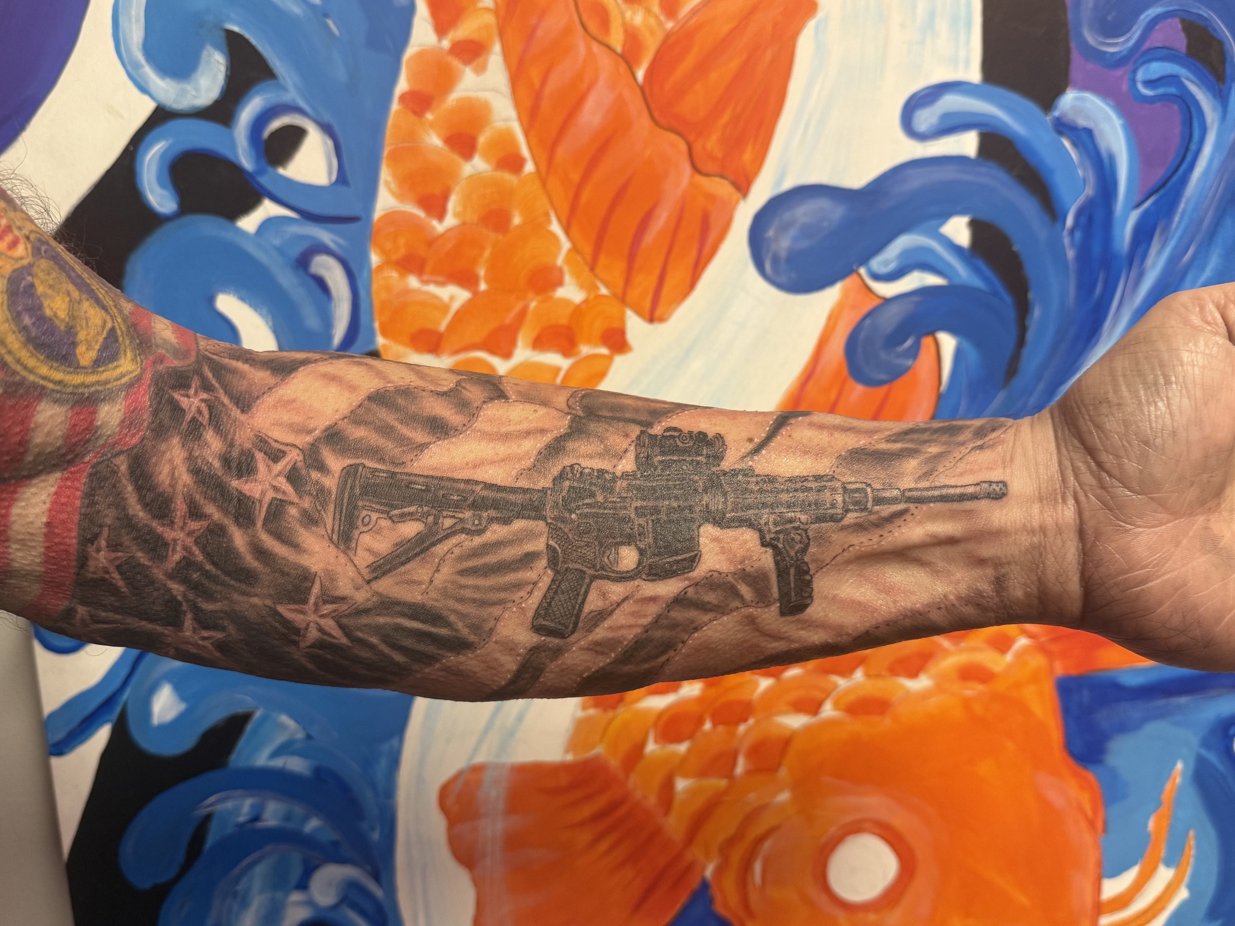 Detailed black and gray forearm tattoo by Joe Kennedy