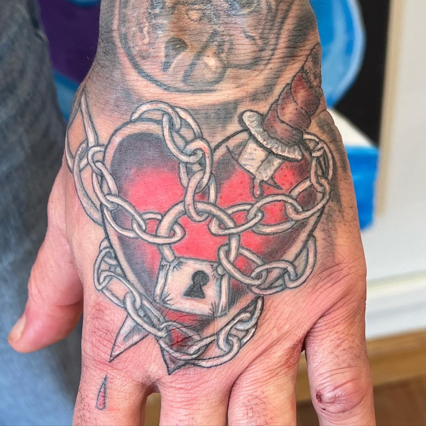 Chain heart hand tattoo by Joe Kennedy