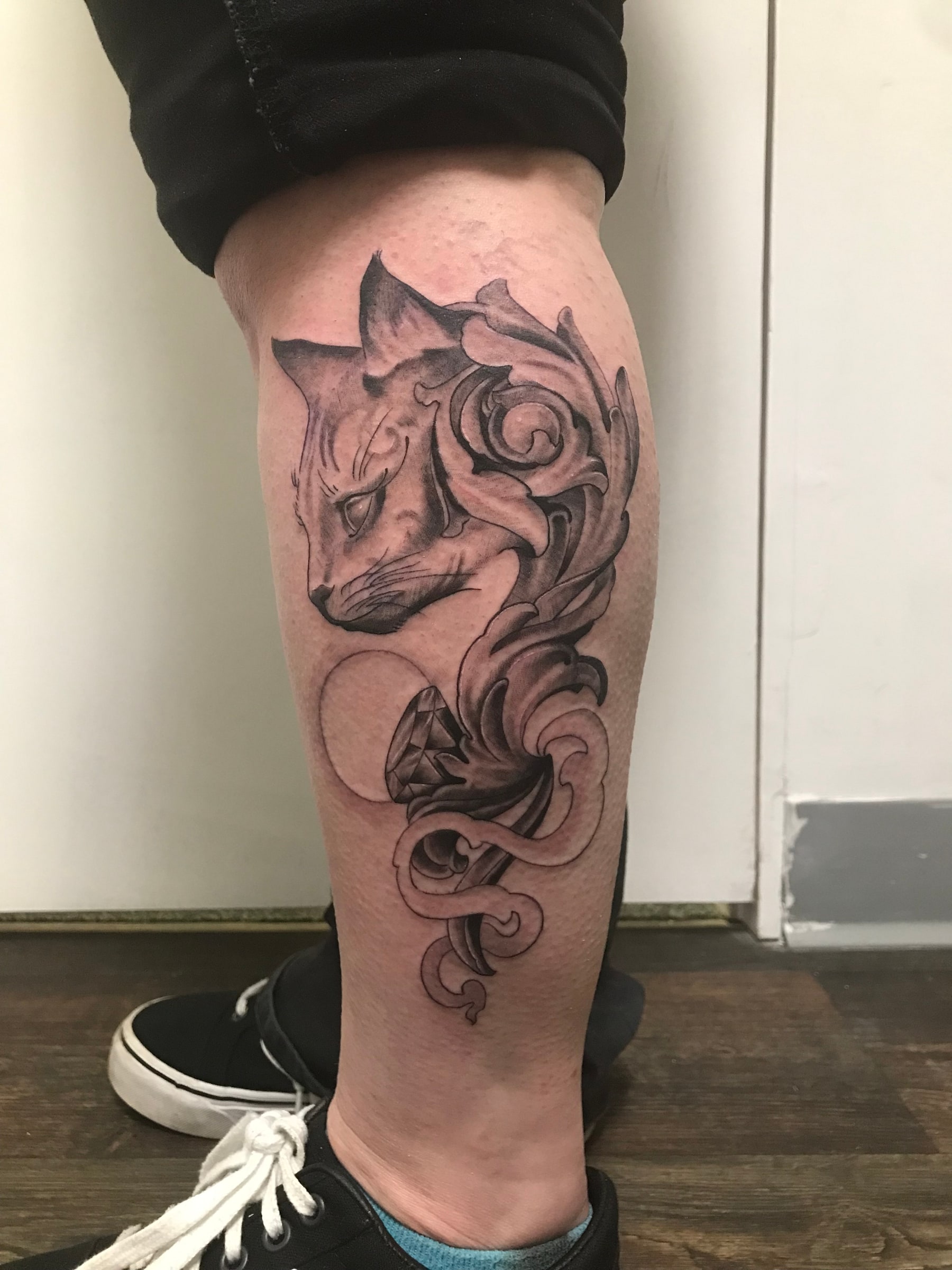 Wolf, rose and diamond calf tattoo by Rob Scotti